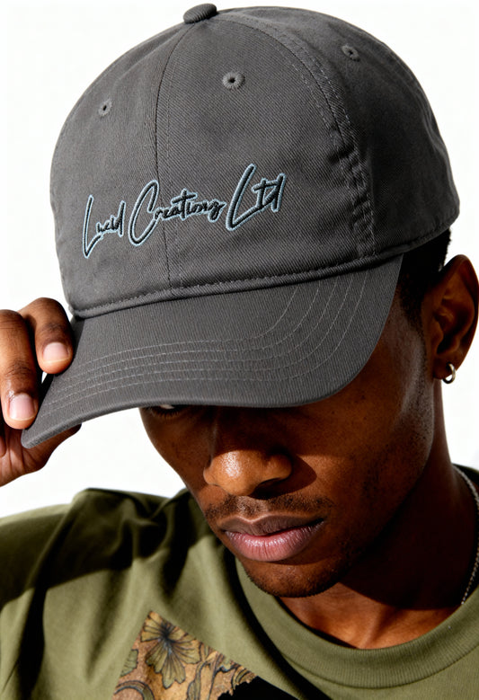 Person wearing a gray cap with 'Lucid Creationz Ltd' text embroidered.